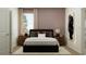 Comfortable bedroom with a dark bed, wooden nightstands, warm lighting, and calming colors at 2251 Rider Rain Ln, Apopka, FL 32703