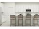 Bright kitchen featuring white cabinetry, stainless steel appliances, and bar stool seating at the counter at 2251 Rider Rain Ln, Apopka, FL 32703
