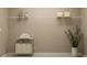 Bright laundry room with rolling laundry cart and ample storage on a white wire shelf at 2251 Rider Rain Ln, Apopka, FL 32703