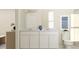 Elegant bathroom with double sinks, white cabinets, stylish mirrors, and modern fixtures at 2341 White Buffalo St, Apopka, FL 32703