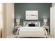 Serene bedroom with a platform bed, ocean-themed art, and a calming color palette at 2341 White Buffalo St, Apopka, FL 32703