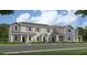 New construction townhome featuring gray siding and decorative shutters with a covered front porch at 2341 White Buffalo St, Apopka, FL 32703