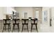 Stylish kitchen features a breakfast bar with seating, white cabinets, and modern stainless appliances at 2341 White Buffalo St, Apopka, FL 32703