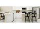 Bright kitchen with white cabinets, an island with bar seating, and stainless steel appliances at 2341 White Buffalo St, Apopka, FL 32703
