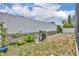Fenced backyard featuring a well-kept lawn, a BBQ grill, and a few potted plants at 2719 Osprey Creek Ln, Orlando, FL 32825