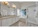 Bright bathroom featuring a double vanity, soaking tub, and a glass enclosed shower at 2719 Osprey Creek Ln, Orlando, FL 32825