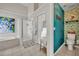 Bright bathroom featuring a walk-in shower, soaking tub, and wallpapered water closet at 2719 Osprey Creek Ln, Orlando, FL 32825