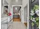 View of the tiled entryway and the spacious living room beyond. Features a glass console table and stylish decor at 2719 Osprey Creek Ln, Orlando, FL 32825