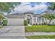 Charming single Gathering home with a well-maintained lawn, two car garage and beautiful landscaping at 2719 Osprey Creek Ln, Orlando, FL 32825