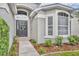 Close up of a welcoming front entrance with a charming wreath, tasteful landscaping and walkway leading to the front door at 2719 Osprey Creek Ln, Orlando, FL 32825