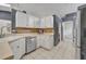 Well-lit kitchen featuring modern appliances, white cabinets, ample counter space, and tile flooring at 2719 Osprey Creek Ln, Orlando, FL 32825