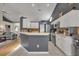 Modern kitchen boasts sleek appliances, white cabinets, breakfast bar and seamless flow into the living room at 2719 Osprey Creek Ln, Orlando, FL 32825