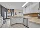 Bright kitchen showcasing stainless steel appliances, white cabinets, tile flooring, and a bar top at 2719 Osprey Creek Ln, Orlando, FL 32825