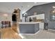 Open kitchen featuring stainless steel appliances, white cabinets, and a breakfast bar that flows into the dining area at 2719 Osprey Creek Ln, Orlando, FL 32825