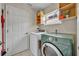 Laundry room featuring washer, dryer, and plenty of storage space at 2719 Osprey Creek Ln, Orlando, FL 32825