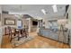 Open concept living room and dining area with a chandelier, skylights, modern decor and hardwood floors at 2719 Osprey Creek Ln, Orlando, FL 32825
