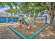 Community playground with a slide, swings, and spring riders under the shade of a tree at 2719 Osprey Creek Ln, Orlando, FL 32825