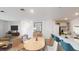 Open-concept living room with dining area, kitchen island and stairs to the second level at 2891 Transformation Way, Clermont, FL 34714