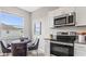 Eat-in kitchen with stainless steel appliances, light cabinets and a breakfast nook with a view of the backyard at 3282 Armstrong Ave, Clermont, FL 34714
