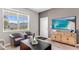 Cozy living room featuring neutral walls, wood-look flooring and lots of natural light from the large windows at 3282 Armstrong Ave, Clermont, FL 34714