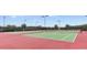 Outdoor tennis court with green playing surface, perfect for enjoying a match in the community at 3282 Armstrong Ave, Clermont, FL 34714