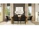 Elegant dining area with a light wood table, seating for six, and natural light from large windows at 3288 Armstrong Ave, Clermont, FL 34714
