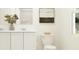 Clean, well-lit bathroom with dual vanities, white cabinets, and modern fixtures at 463 Puma Loop, Groveland, FL 34736