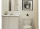 Bright bathroom with white vanity, modern fixtures, a decorative mirror and a neutral color scheme at 463 Puma Loop, Groveland, FL 34736