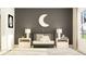 Modern Bedroom room featuring a crib, moon decor, two lamps, and a cozy rug at 463 Puma Loop, Groveland, FL 34736