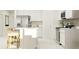 Bright kitchen featuring white cabinets, stainless steel appliances and a quartz-topped breakfast bar at 463 Puma Loop, Groveland, FL 34736
