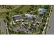 Aerial view of a community clubhouse, pool, tennis and pickleball courts, parking, and landscaping at 5611 Vinyasa Rd, Clermont, FL 34714