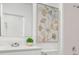 Well-lit bathroom featuring modern fixtures, a large mirror, and a tiled shower at 5611 Vinyasa Rd, Clermont, FL 34714