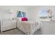 Bright bedroom featuring a large window, comfortable bed, and white furnishings at 5611 Vinyasa Rd, Clermont, FL 34714