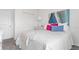 Comfortable bedroom with a closet, bed with decorative pillows, and neutral color palette at 5611 Vinyasa Rd, Clermont, FL 34714