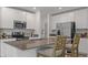 Modern kitchen featuring white cabinetry, stainless steel appliances, and a center island with barstool seating at 5611 Vinyasa Rd, Clermont, FL 34714