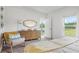 Bright and airy main bedroom featuring a dresser, a comfortable chair, and a view of the outdoors at 5611 Vinyasa Rd, Clermont, FL 34714