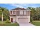 Charming two-story home featuring manicured landscaping and a convenient two-car garage, offering curb appeal and practicality at 5615 Vinyasa Rd, Clermont, FL 34714