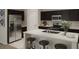 Modern kitchen featuring stainless steel appliances, a large island with seating, and dark cabinetry for a sleek design at 5615 Vinyasa Rd, Clermont, FL 34714
