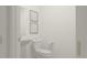 Clean, modern half-bathroom with sleek toilet and sink, accentuated by minimalist decor at 5660 Vinyasa Rd, Clermont, FL 34714