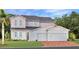 Charming two-story home featuring a spacious two-car garage and nicely landscaped front yard at 5660 Vinyasa Rd, Clermont, FL 34714