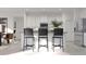 Bright kitchen featuring a large center island with bar seating, modern appliances, and stainless steel refrigerator at 5660 Vinyasa Rd, Clermont, FL 34714