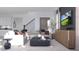 Modern living room featuring a plush sofa, stylish coffee table, and built-in staircase at 5660 Vinyasa Rd, Clermont, FL 34714