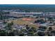 Community aerial view showcases nearby baseball field, running track, and surrounding neighborhood at 1205 Crestwood Dr, Winter Haven, FL 33881