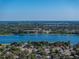 Gorgeous aerial view showcases the neighborhood near a pristine lake with clear blue skies at 1205 Crestwood Dr, Winter Haven, FL 33881