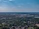 Aerial view of the community with nearby lake and industrial area in the distance at 1205 Crestwood Dr, Winter Haven, FL 33881