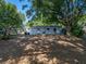 This backyard features mature trees, offering shade and privacy at 1205 Crestwood Dr, Winter Haven, FL 33881