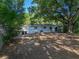 This backyard is surrounded by mature trees, offering shade and privacy at 1205 Crestwood Dr, Winter Haven, FL 33881