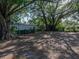 Expansive backyard featuring mature trees, providing plenty of shade and privacy at 1205 Crestwood Dr, Winter Haven, FL 33881