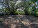 Large backyard has mature trees and plenty of space for recreation or gardening at 1205 Crestwood Dr, Winter Haven, FL 33881