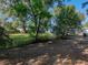 Large grassy backyard bordered by a chain-link fence and mature trees at 1205 Crestwood Dr, Winter Haven, FL 33881
